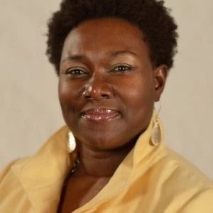 Portrait photo of Terrasel Jones. She is wearing a yellow short and has short curly black hair.