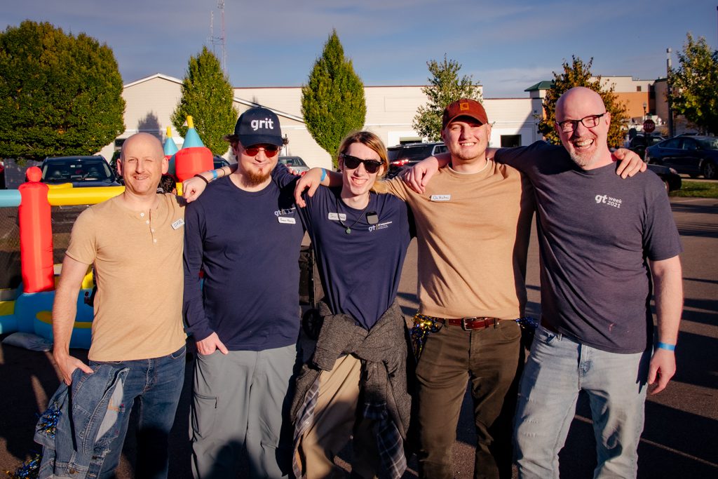 A group of GT employees smiling at the 20th Anniversary GT Week block party.